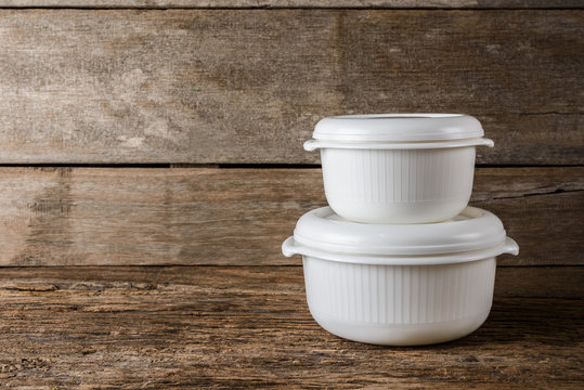Empty containers for food on wooden background