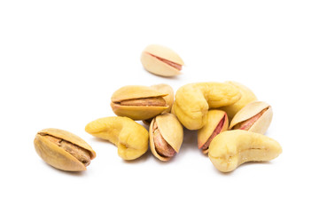 Pile of roasted pistachios and cashew isolated on white background