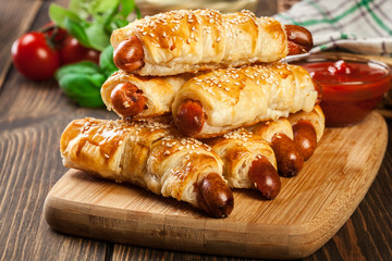 Rolled hot dog sausages baked in puff pastry