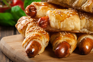 Rolled hot dog sausages baked in puff pastry