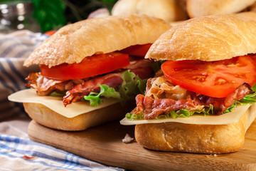 Ciabatta sandwich with smoked bacon, cheese and tomato
