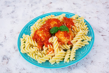 Meatballs with fusilli on white background