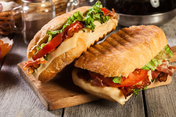 Toasted ciabatta sandwich with smoked bacon, cheese and tomato - obrazy, fototapety, plakaty