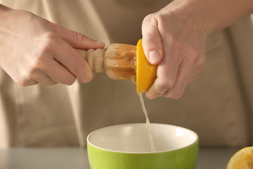 Woman preparing lemonade in kitchen, closeup
