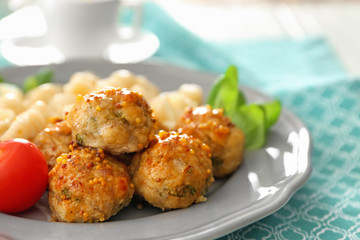 Plate with turkey meatballs and pasta on table, closeup