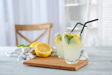 Glasses of fresh lemonade on table