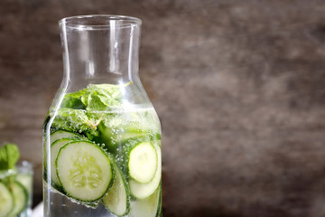 Bottle of fresh cucumber lemonade on grunge background