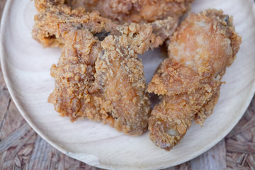 Fried chicken wings on wooden dish