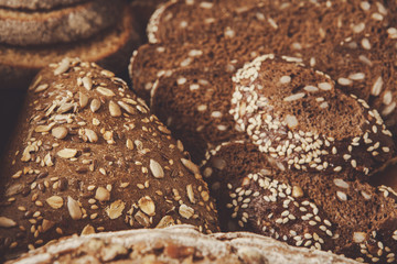 Bread background, closeup of white, black and rye loaves