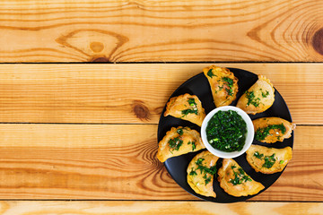 Baked dumplings with dill sauce. Top view