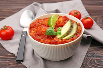 Bowl with delicious chili turkey on napkin