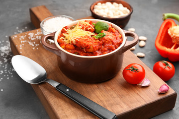 Casserole with delicious chili turkey on wooden board