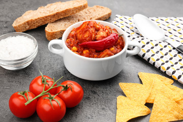Casserole with delicious chili turkey on table