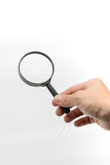 Woman hand holding black magnifier glass