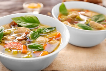 Bowl with delicious turkey soup on table, close up