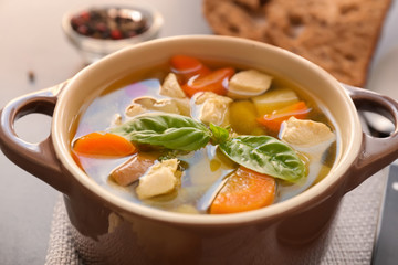 Casserole with delicious turkey soup on napkin, close up