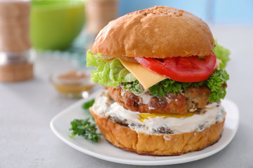Tasty turkey burger on table