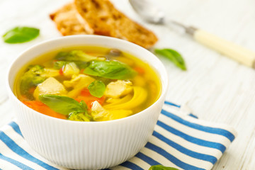 Bowl with delicious turkey soup on napkin
