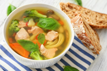 Bowl with delicious turkey soup on napkin
