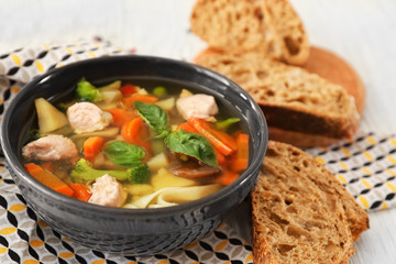 Bowl with delicious turkey soup on napkin
