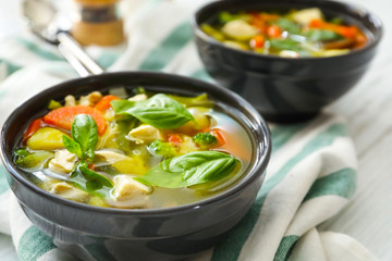 Two bowls with delicious turkey soup on napkin