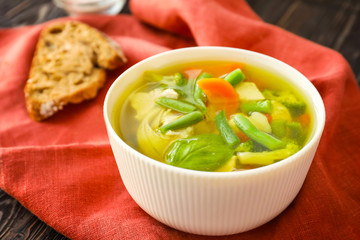 Bowl with delicious turkey soup on napkin