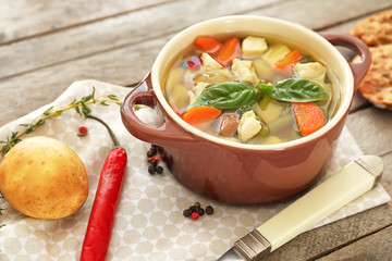 Casserole with delicious turkey soup on napkin