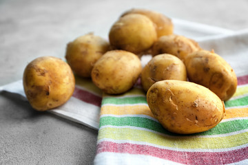 Raw organic potato on grey background