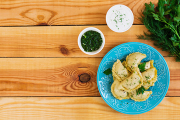 Delicious dumplings with cabbage on wooden background