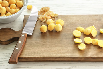 Composition with raw organic potatoes on wooden table