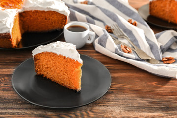 Tasty slice of carrot cake on black plate