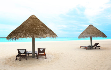 View of sea beach with sun loungers and umbrellas on summer day