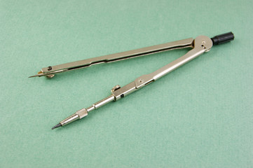 Old drawing tools on a green background