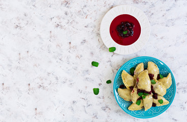 Delicious dumplings with cherry on white background