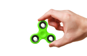 Green hand spinner in man’s hand isolated on white background
