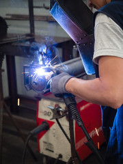 Use of wire welding machine in a workshop.