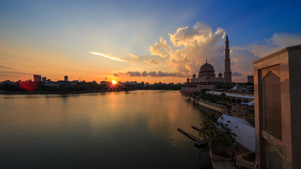 scenery of sunset with beautiful and stunning sun ray in the cloud at Putra Mosque, Putrajaya