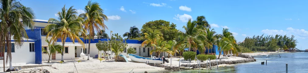 Wall murals Caribbean Peaceful bay with fishing boat on caribbean island / Very calm bay with turtle farm on so called island of "Isla Mujeres" in Cancun Mexico