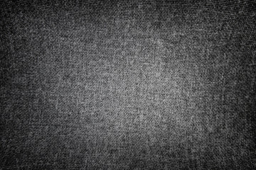 Black and white stretched canvas. Fabric texture with vignette.