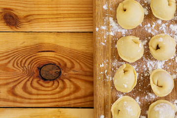 Fototapeta na wymiar Meat dumplings, ravioli, on wooden background