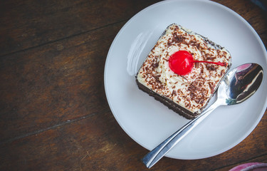 tasty chocolate cherry cake dessert on wood table