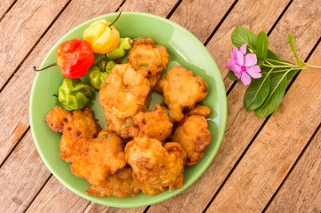 Salt cod fritters (accras de morue) on a plate with habanero peppers in Martinique