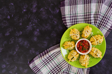 Delicious manti dumplings on dark background
