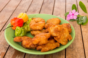 Salt cod fritters (accras de morue) on a plate with habanero peppers in Martinique