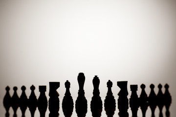 Silhouette of chess pieces on a white background