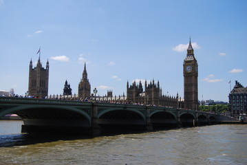 Fototapeta na wymiar London, United Kingdom - July 22, 2014: Typical summer day in London, tourists walking over Westminister bridge