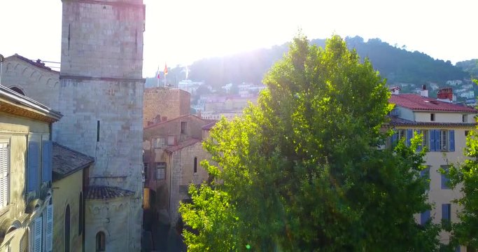 NOTRE-DAME DU PUY  CATHEDRAL in typical Provence town GRASSE, French perfume capital, Alpes-Maritimes.  View of Old Town  and Houses with a red tile, a bell tower, a mountain, sunset. France