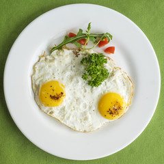 frying eggs with tomatoes