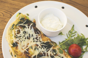 Hot pizza slice with melting cheese on a rustic wooden table. Delicious meal in the restaurant on a sunny day.