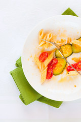 Italian penne pasta with zucchini and cherry tomatoes